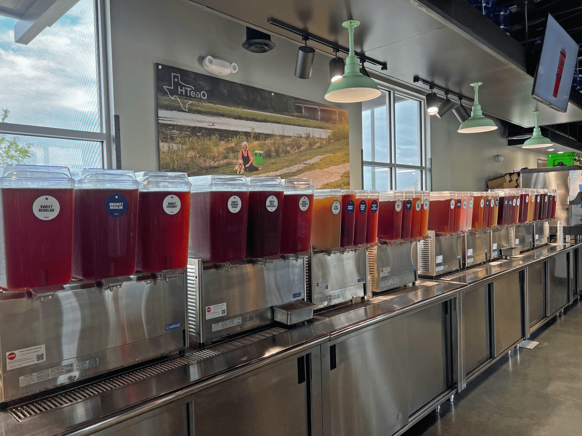 A row of containers filled with different colors and flavors of tea.