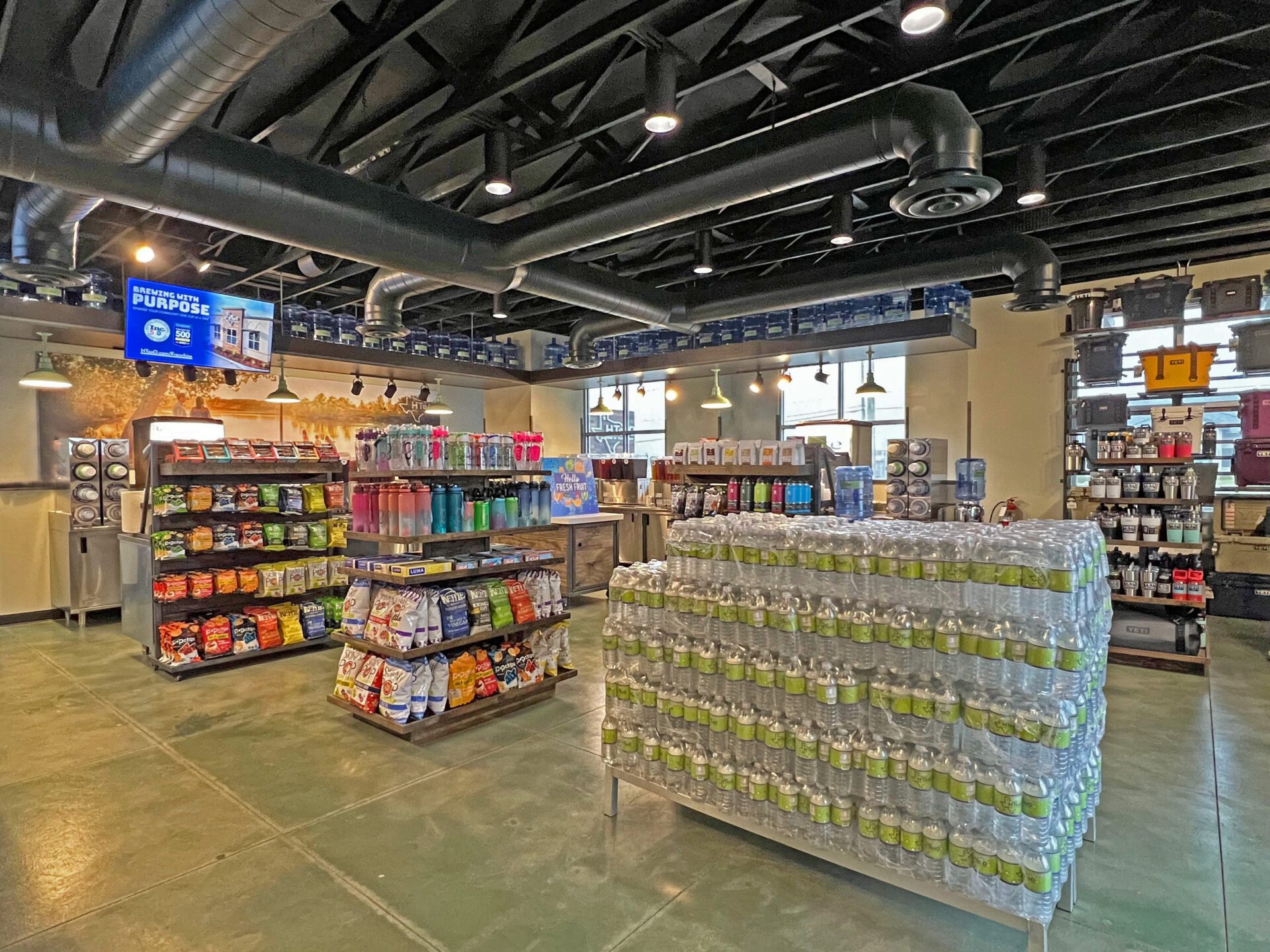 Overview of the inside of the building, with different displays featuring merchandise, snacks, and water.