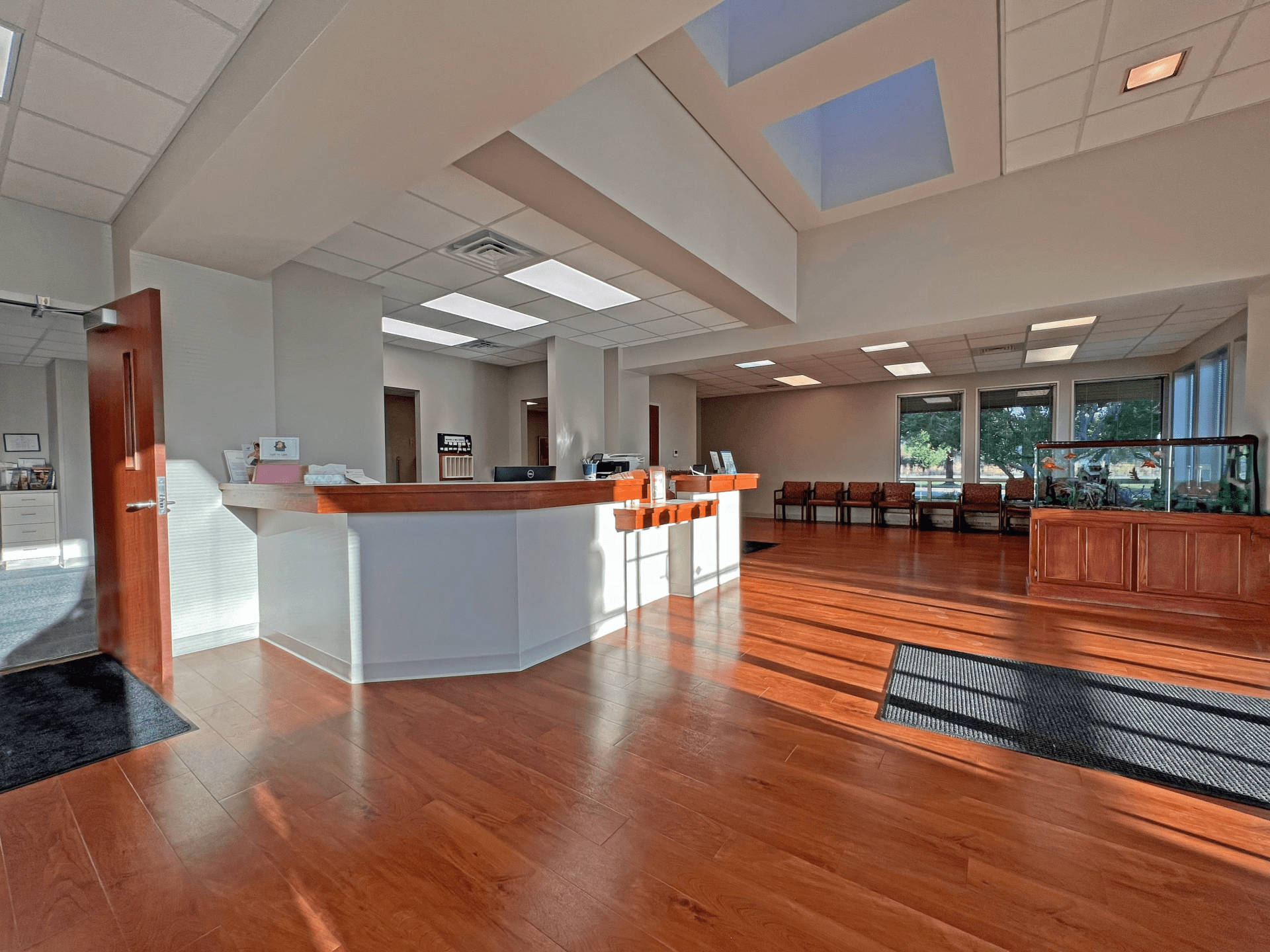 Reception area with a desk, open seating, and a fishtank