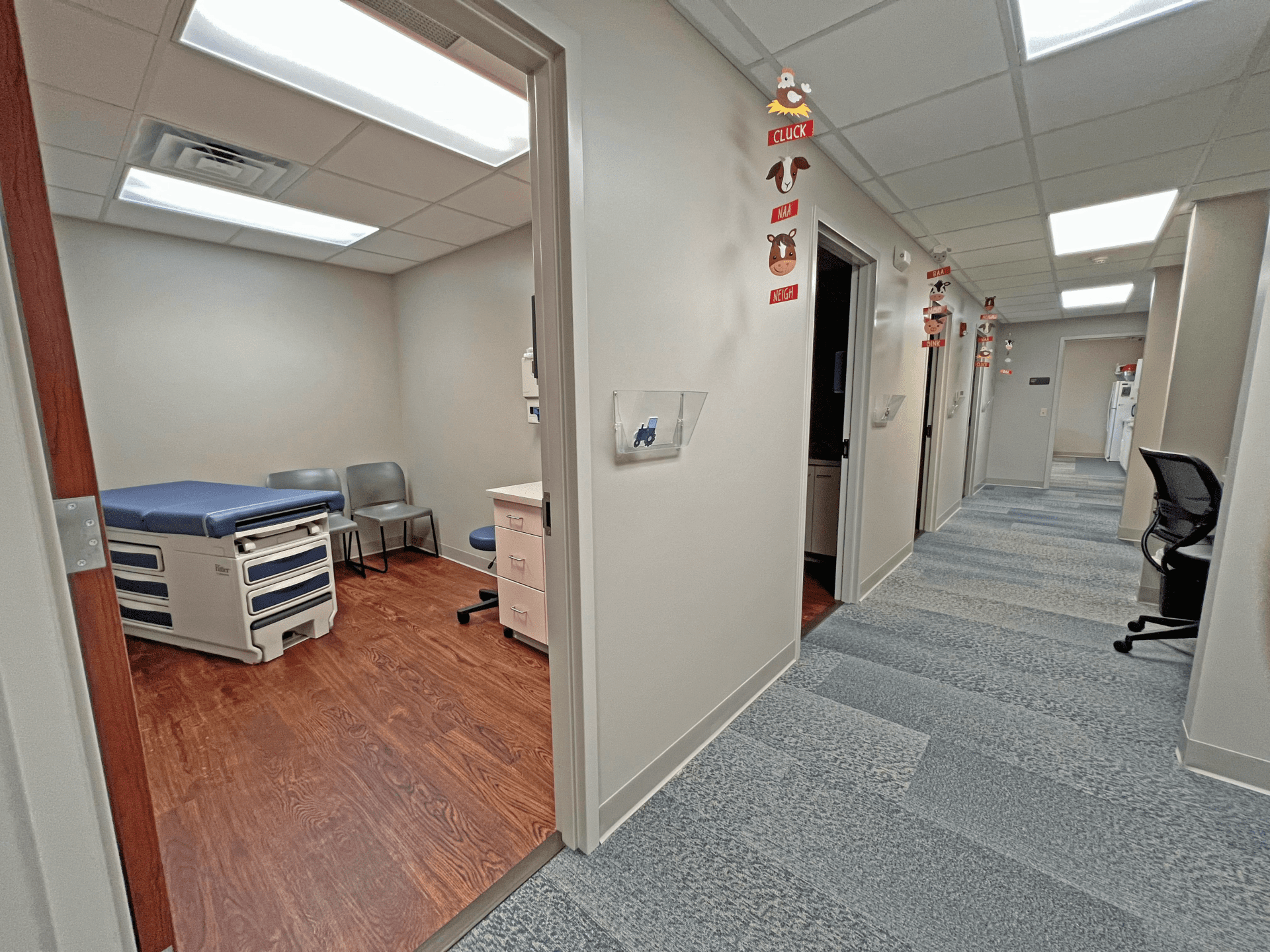 A hallway with doorways to exam rooms.