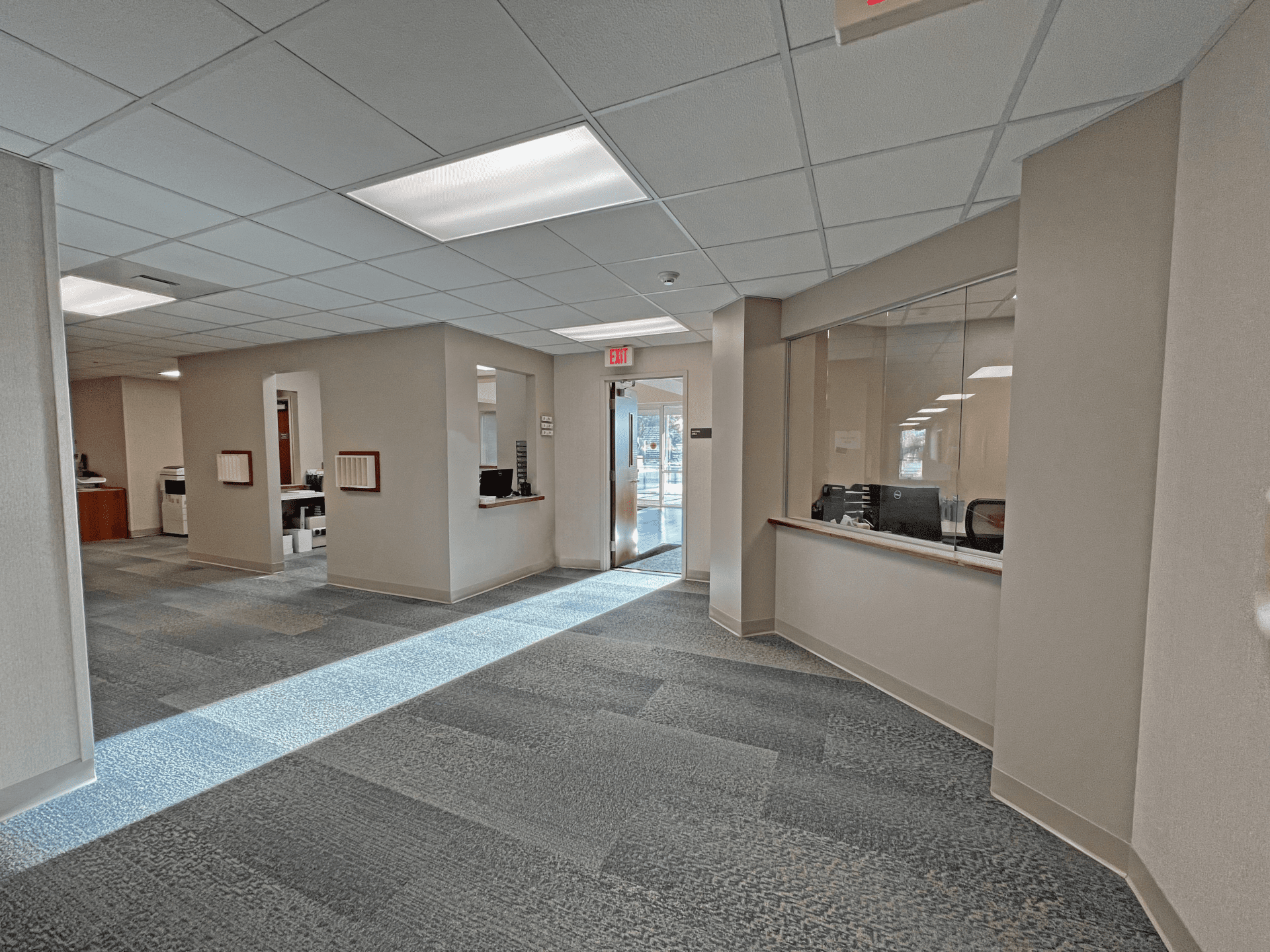 Curved hallway with two check out counters and a doorway to the lobby