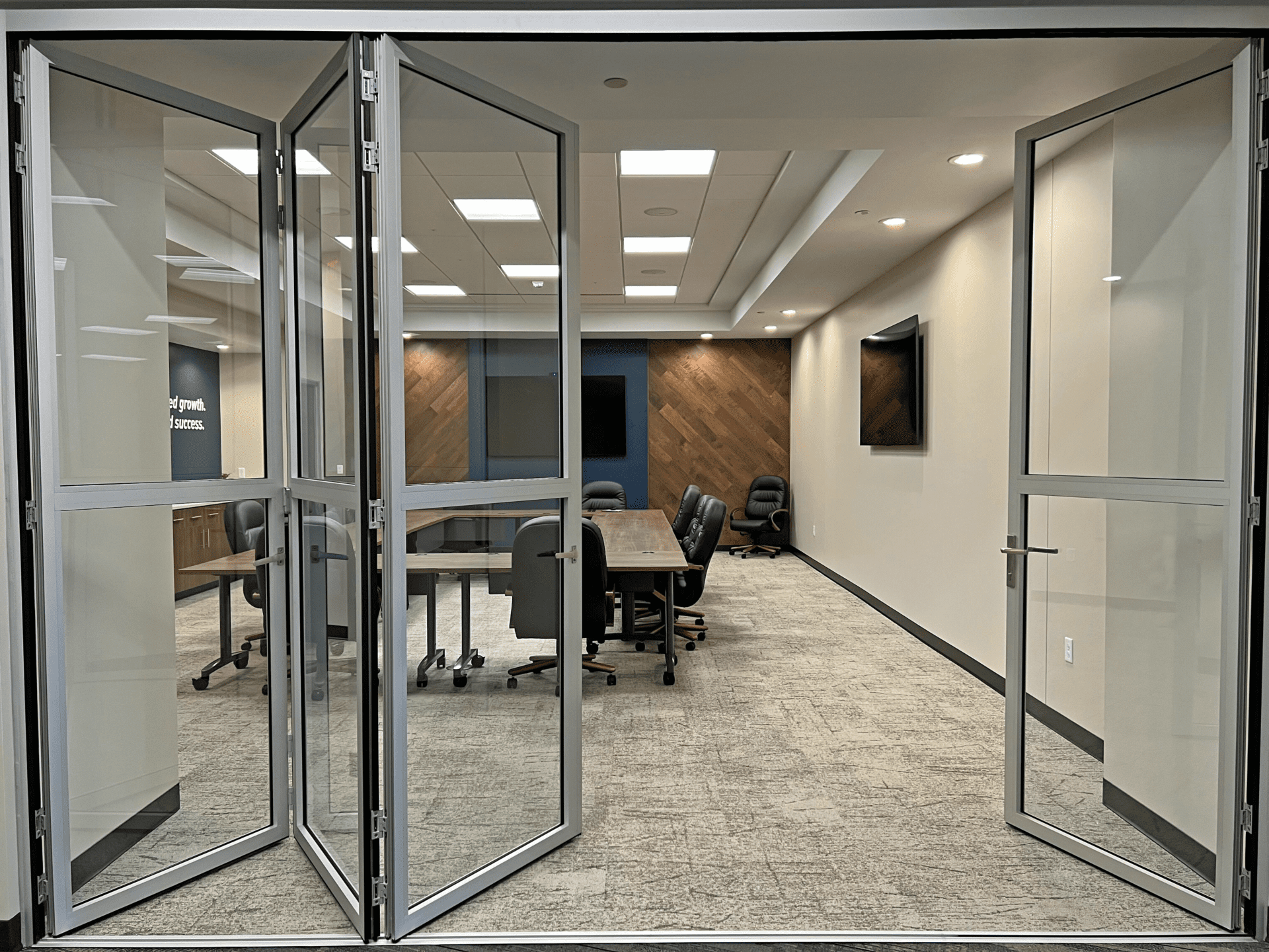 Bifold glass doors leading to a conference room
