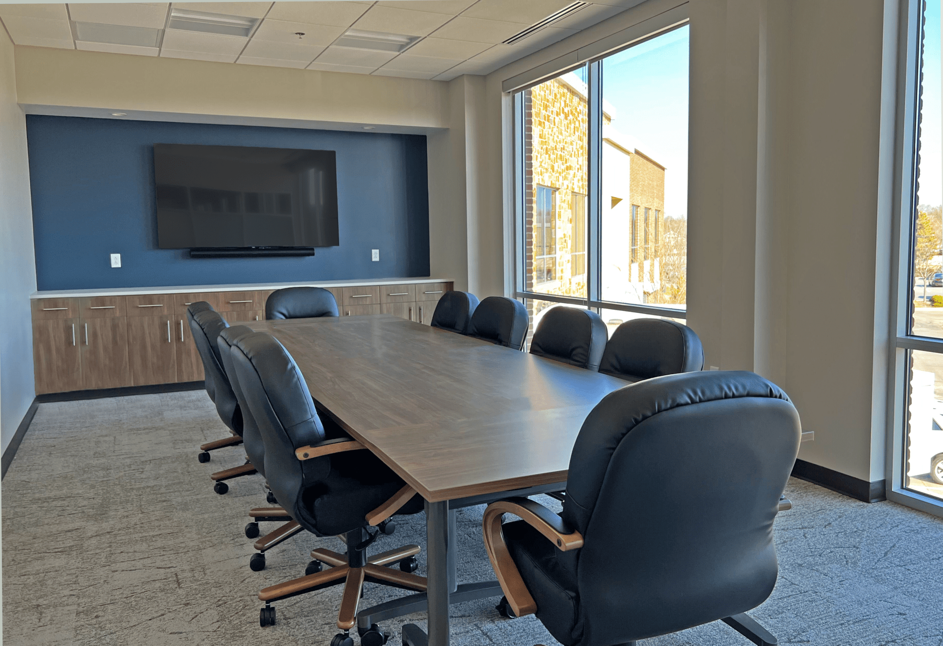 A conference room with a wall of windows.