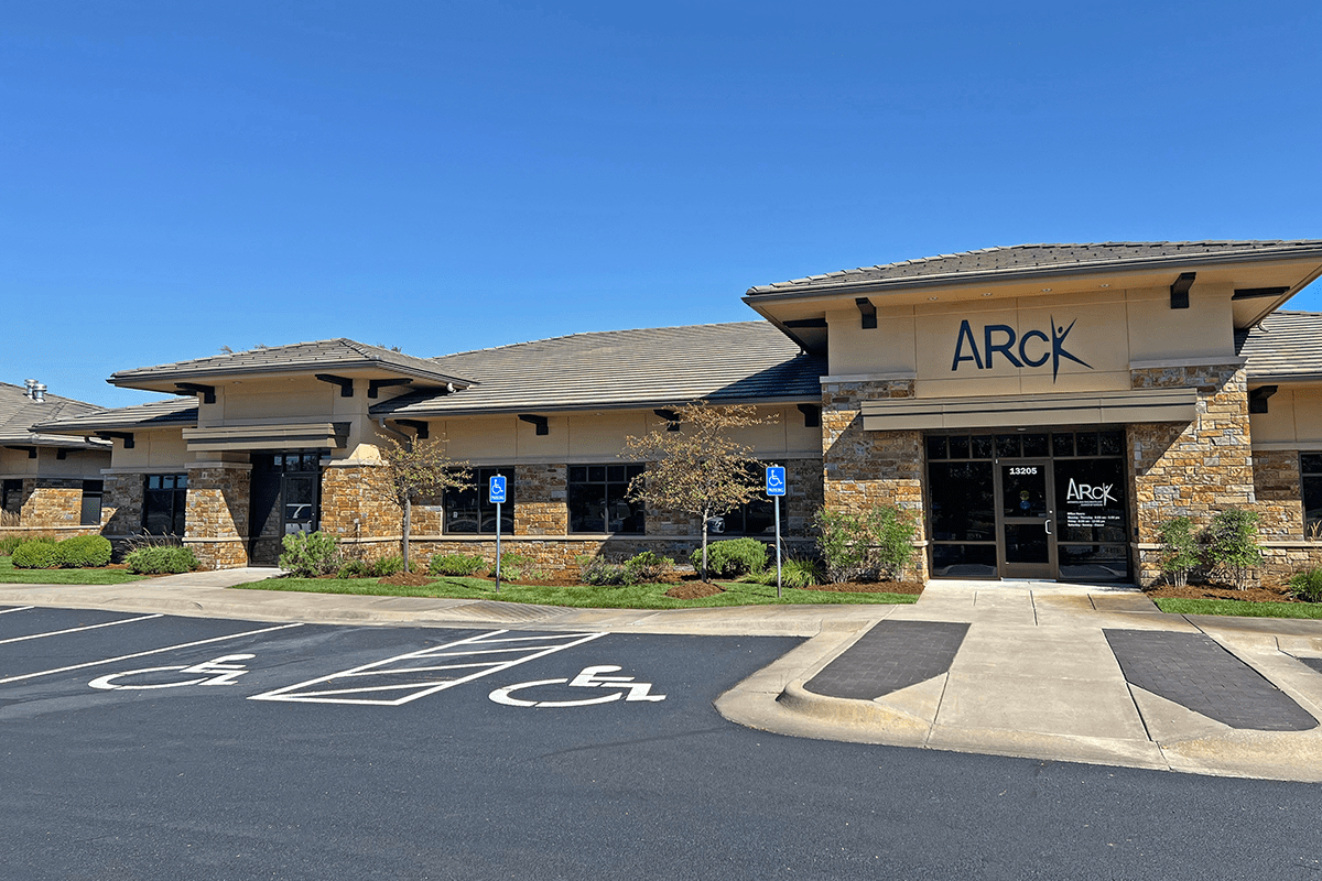 Exterior of a medical office with signage, ADA parking stalls, masonry, and landscaping.