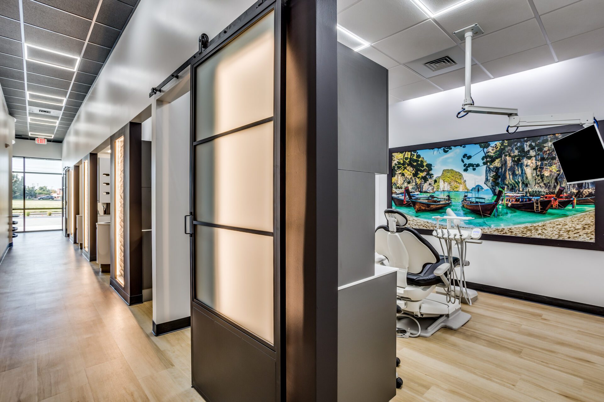 Hallway and dental exam room with a large mural on the wall