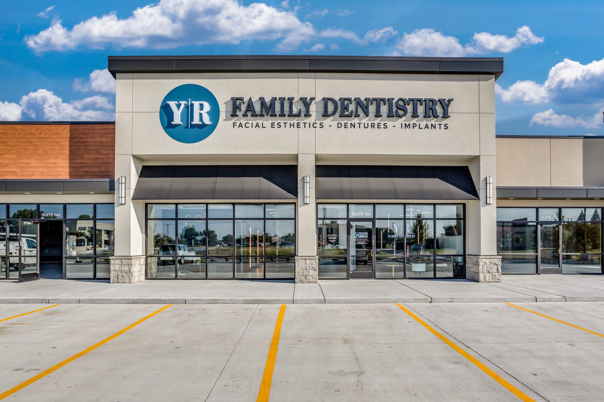 Exterior of YR Family Dentistry's office with storefront glass and signage.