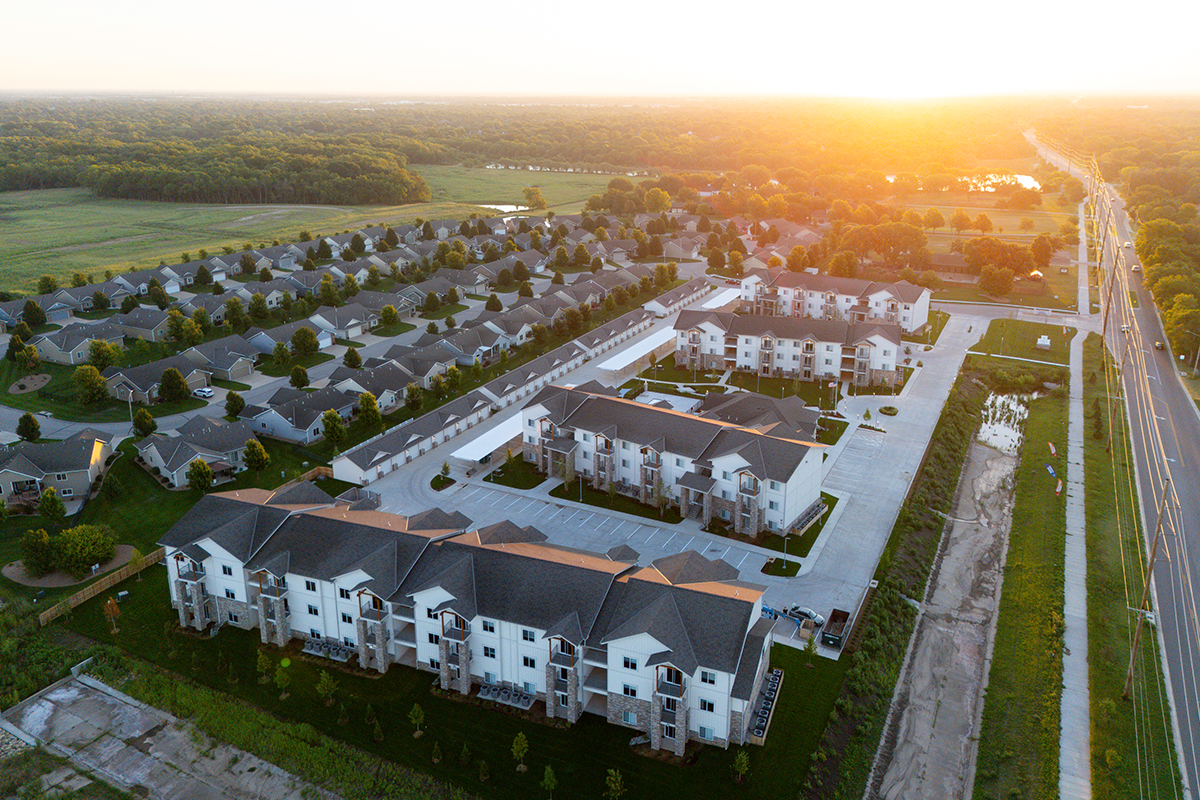 An aerial view of an apartment complex at sunset.