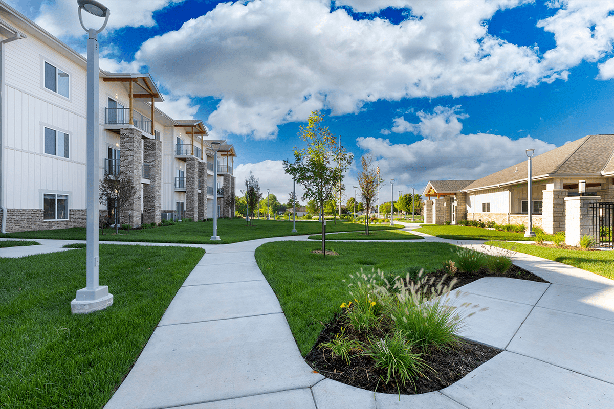 A well-maintained apartment complex with walkways and landscaping.