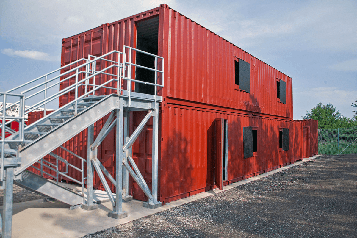 shipping containers stacked on top of each other with stairs